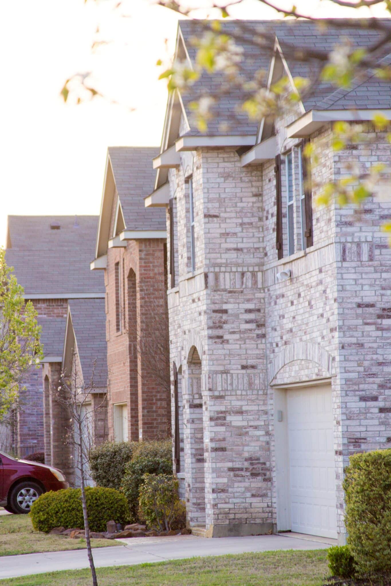 A row of two-story brick suburban homes in a San Antonio neighborhood, showcasing the types of residential properties evaluated by Gatewood Superior Inspections.